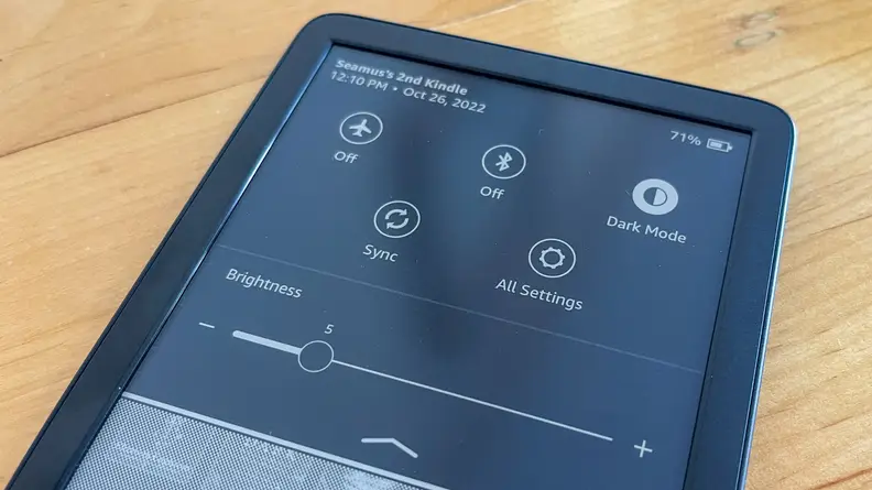 A Kindle with it's settings pane open, showing a number of options that can be tapped on or off.
