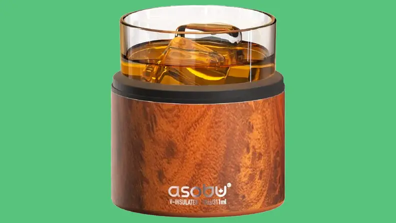 Insulated whiskey glass on green background