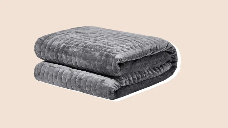 A gray soft quilted washable Gravity weighted blanket with soft microfiber on a neutral background.