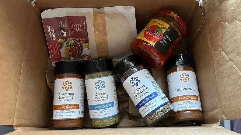 A box filled with Savory Spice's products.