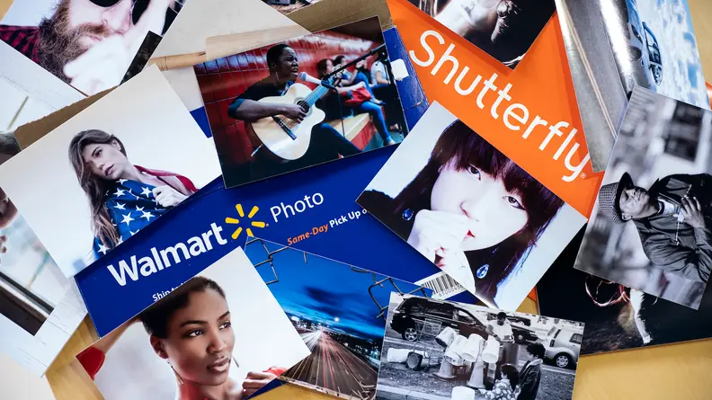 A large stack of photos, Walmart and Shutterfly logos