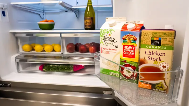 The interior of the Hisense HRF266N6CSE French-door refrigerator, showing its door bins and crispers, all filled with colorful food items.