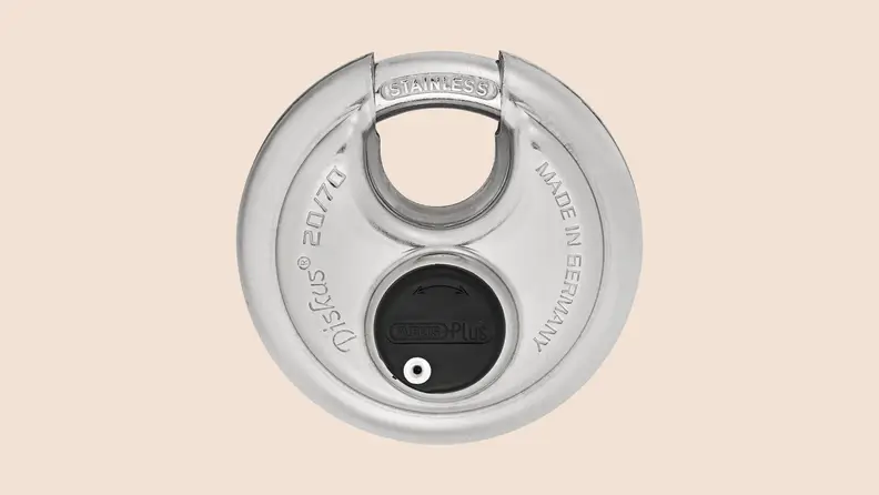 ABUS Diskus disk padlock against a plain beige background