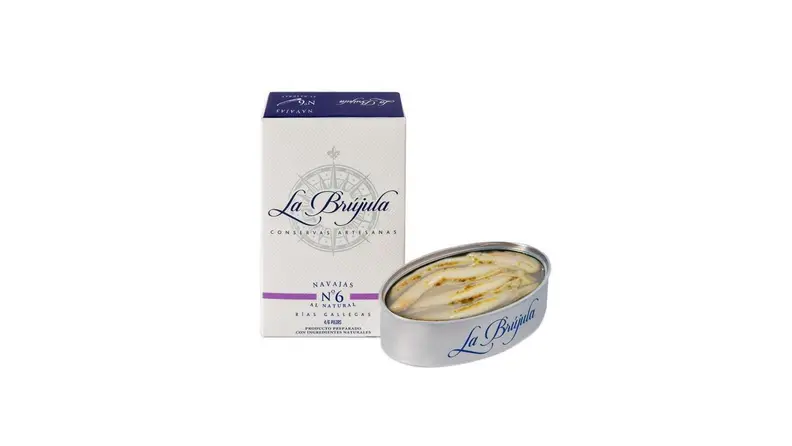 An open tin of fish next to its packaging.