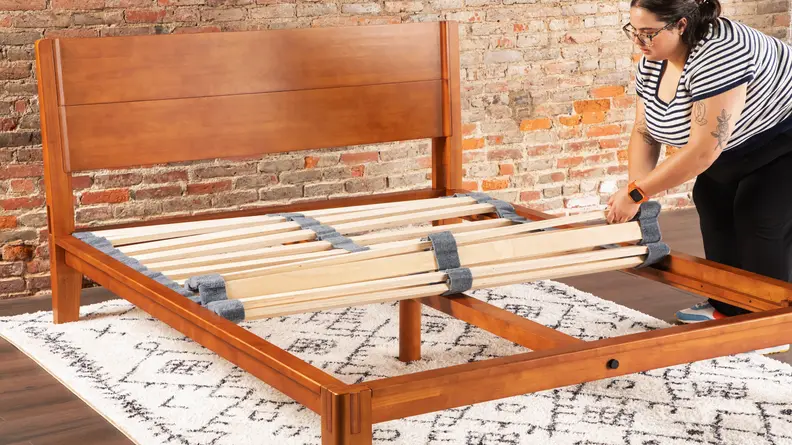 A woman building the bed frame.