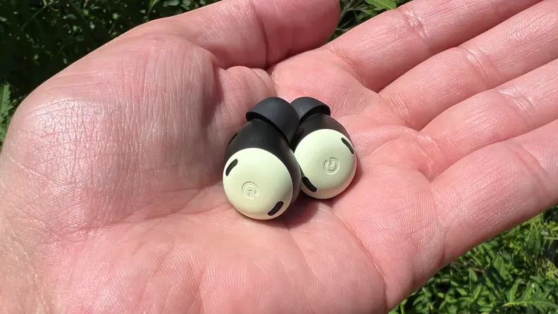 A pair of Pixel Buds Pro held in a hand.