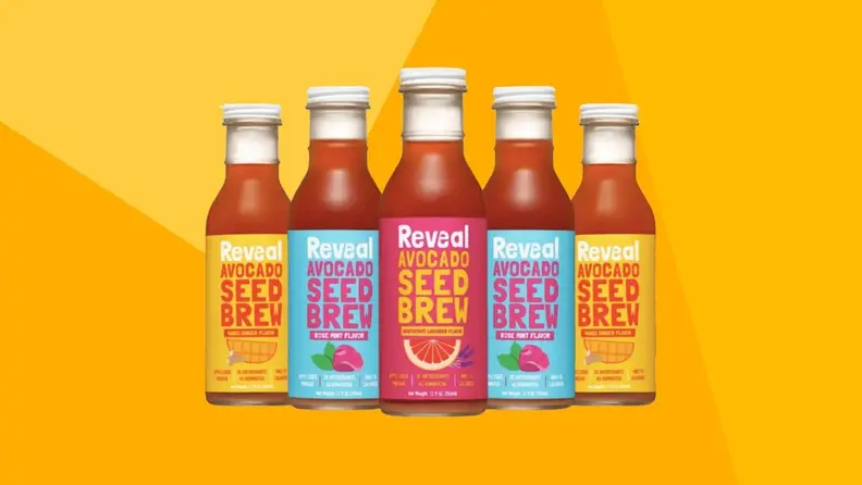 Five bottles of juice bottles against a yellow background.
