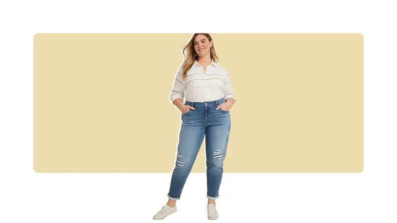 A model wearing cropped blue jeans and a striped white top.