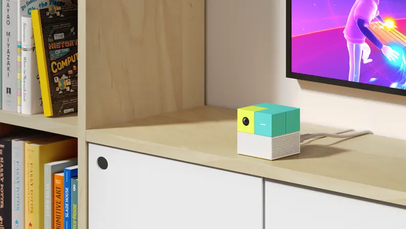 The Nex Playground sitting on a TV stand below a TV