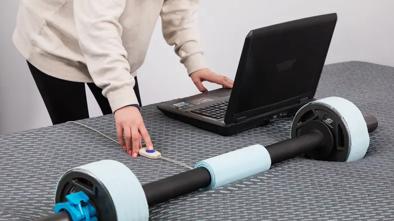 A person measuring the pressure points on the Tuft & Needle Mint hybrid mattress.
