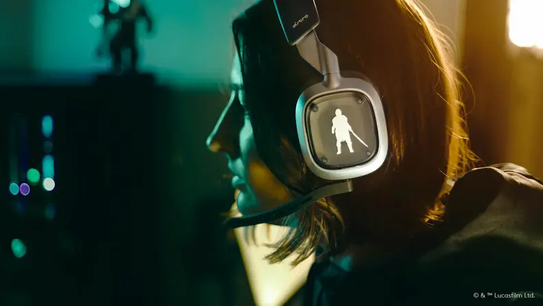 A logitech gaming headset in grey with Mandalorian-themed side cutouts