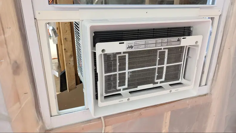 The A/C unit being built on a wall.