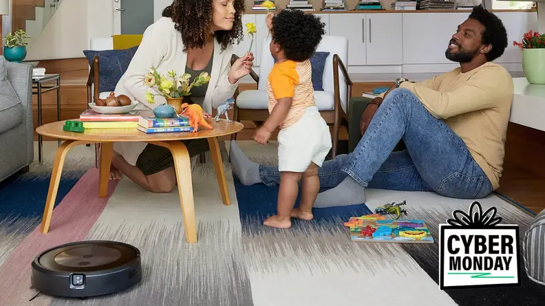Image of family playing on the floor next to a robot vacuum
