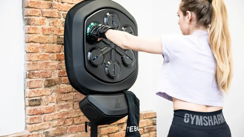 A woman punching the Liteboxer machine.