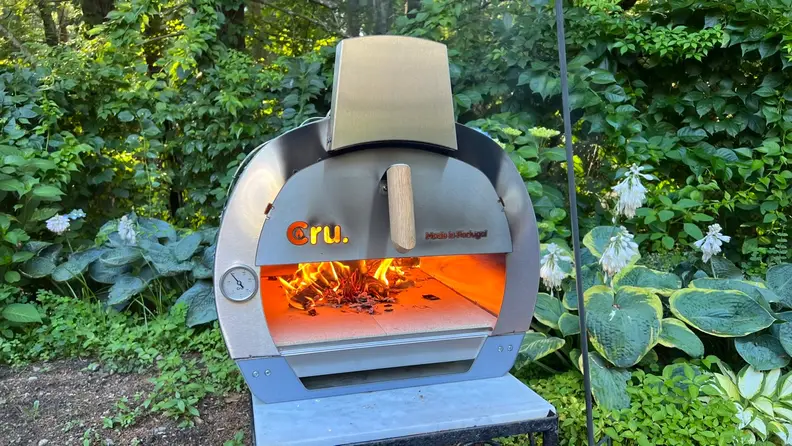 The Cru 32 Pizza oven with a roaring fire inside.