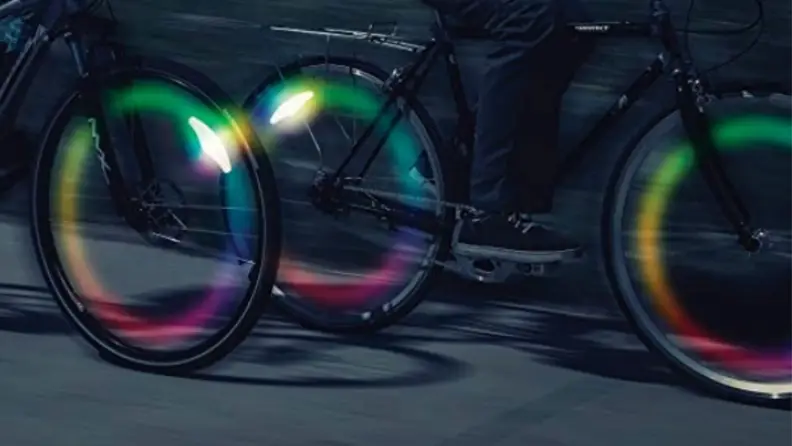 A series of lit-up bike wheels with spoke lights.