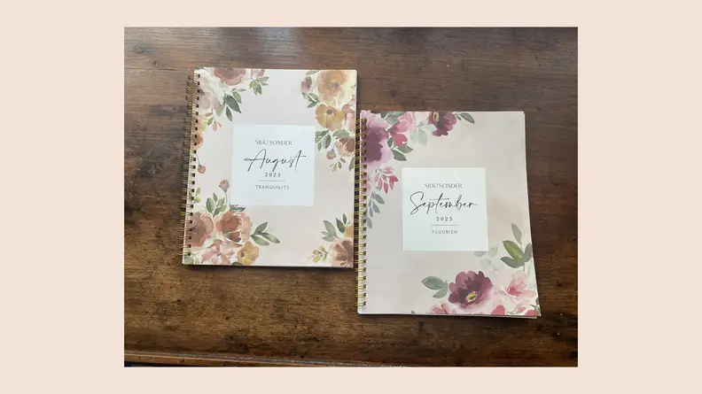 open journal on pink background