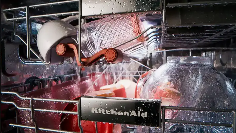 A loaded upper and third rack get sprayed with water