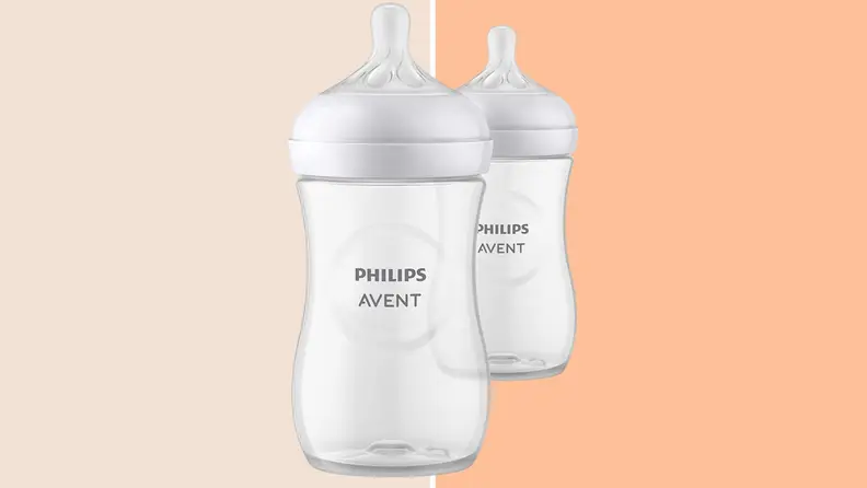 The Philips Avent Natural baby bottle against a two tone orange background.