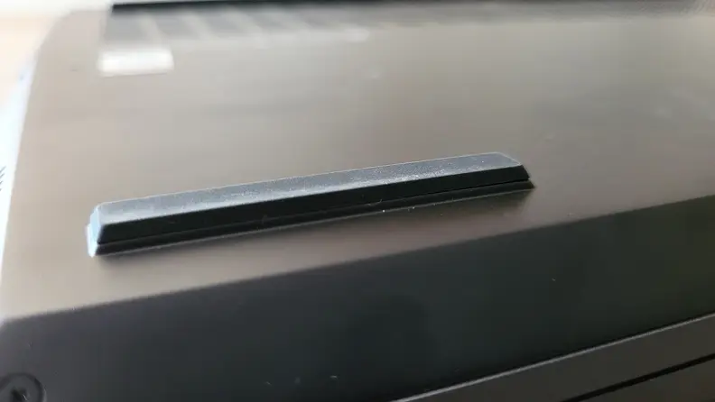 View of one of the feet on the bottom of a laptop