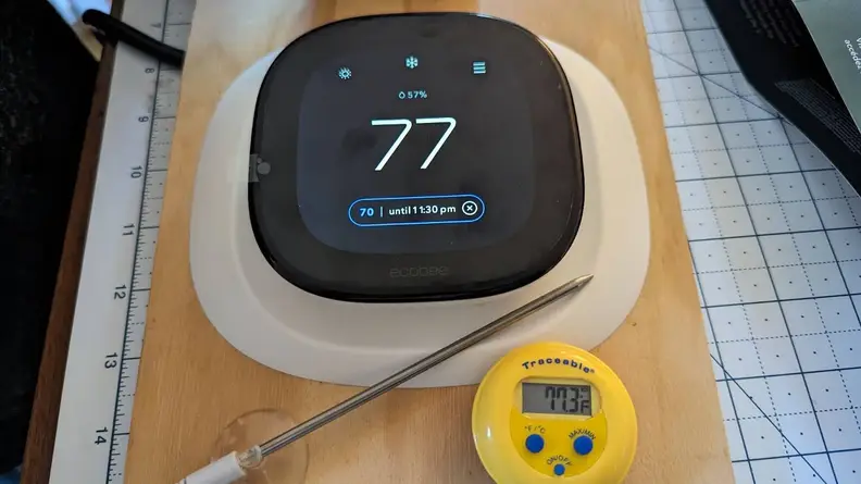 The Ecobee Enhanced thermostat appears with a thermometer in testing.