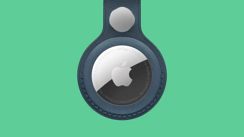 Apple Airtag in leather loop on colored background