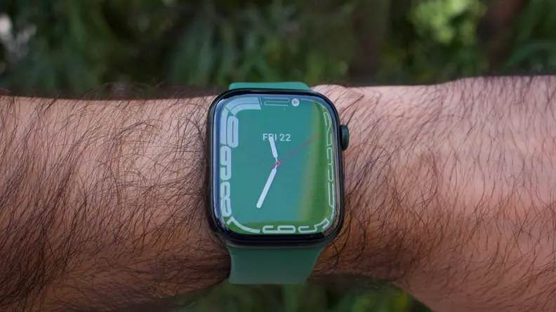 A close-up of the Apple Watch Series 7, in green, showing the new Contour watchface, which wraps the numbers around the edge of the display.