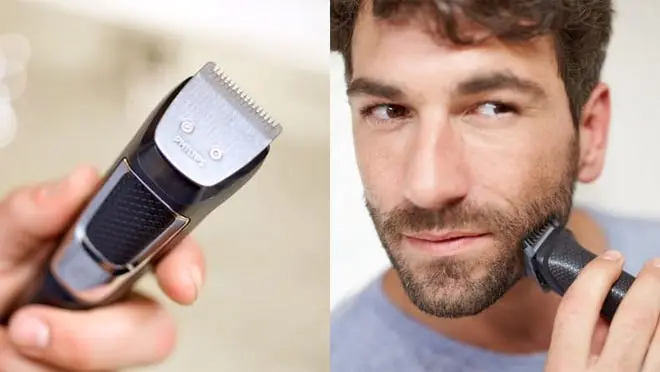 A person uses a beard trimmer