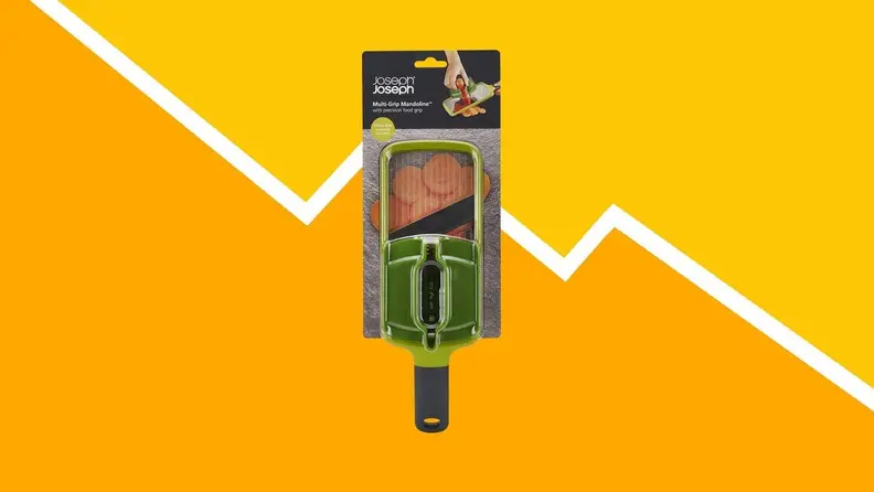 A mandoline slicer against a yellow background.