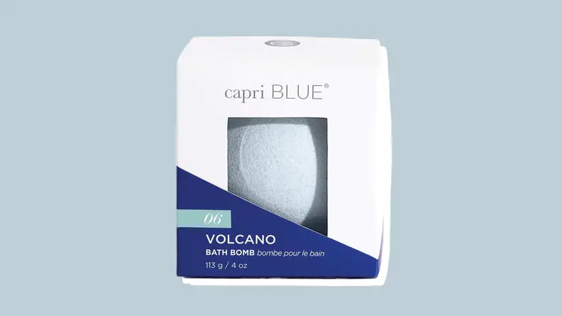 Capri Blue bath bomb against a grey-blue background.
