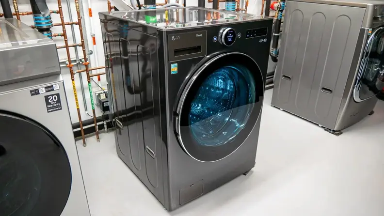 Angled photo of the front of an LG WM6700HBA front-load washing machine unit in the Reviewed testing laboratory.