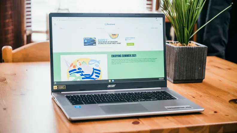 An open and powered on laptop on top of a desk