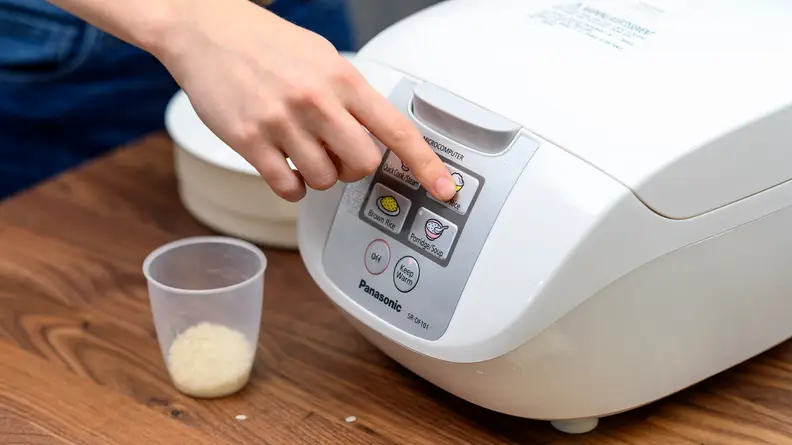 To cook white rice in the Panasonic One-Touch rice cooker, press "white rice" button after closing the lid.
