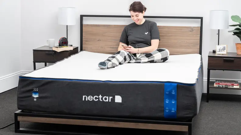 A person sitting on a Nectar mattress.