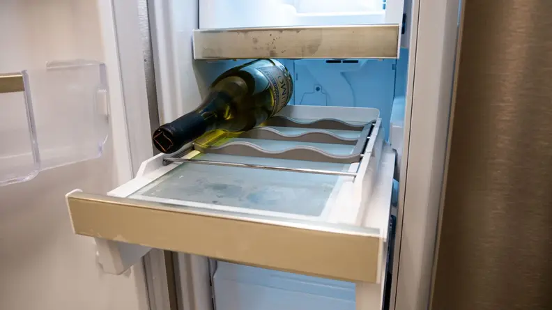 Wine bottle on rack in the Custom-Flex Temp Zone inside the Frigidaire Gallery Quattro GRQC2255BF 4-Door French-Door Refrigerator.