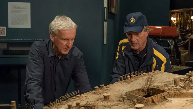 James Cameron leaning over Titanic replica