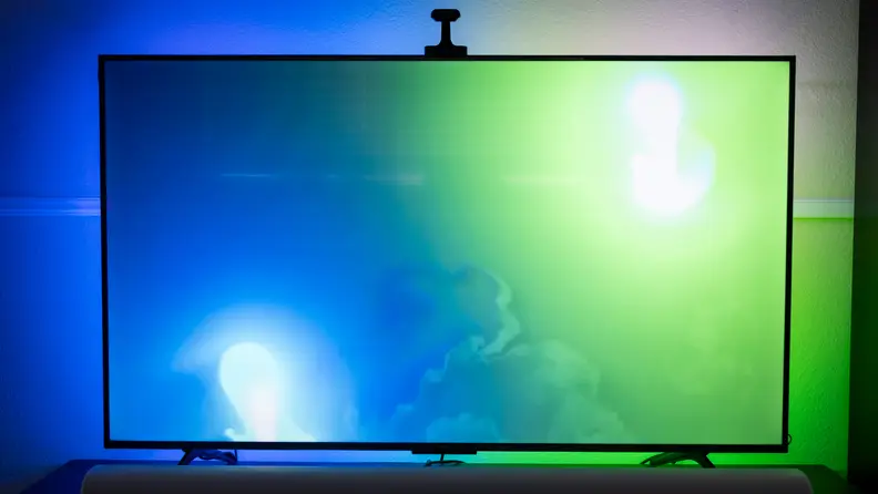 Full 55-inch TV shown with Govee TV Backlight displaying blue and green colors behind it.