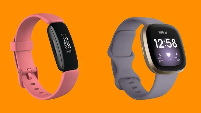 A pink and a gray Fitbit against an orange background.