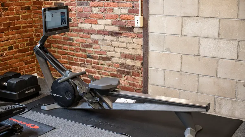 A Hydrow Rower rowing exercise machine in a gym setting.
