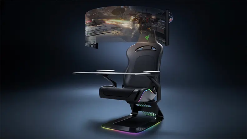 A retractable display screen encircles a Razer gaming chair for bleeding-edge immersion. There are colored lights along the edges of the chair.