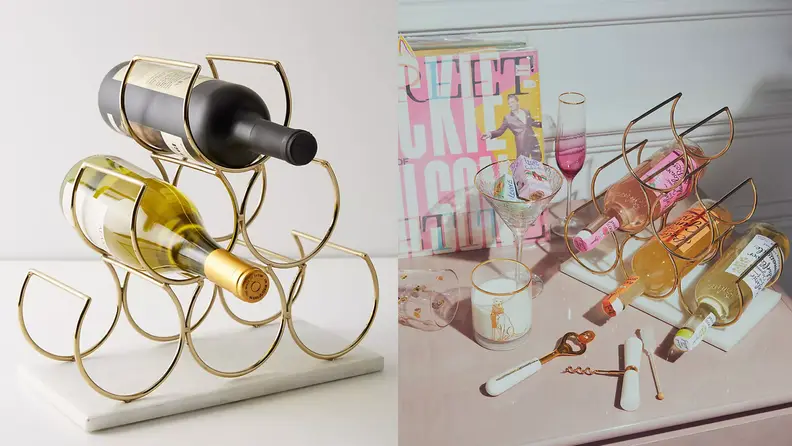A 6 bottle wine rack with a red bottle and a white bottle in it.