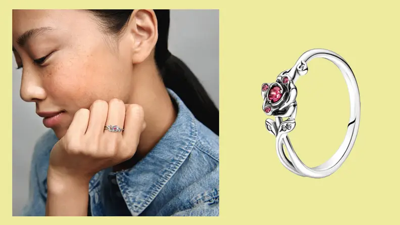 A closeup of the 'Beauty and the Beast' rose in silver with four red stones in the rose.