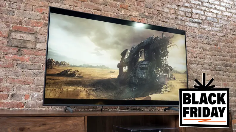 A TV sitting on a table in front of a brick wall.