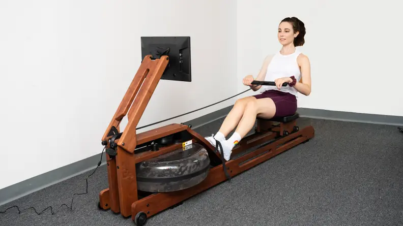 Woman rowing on Ergatta rowing machine.