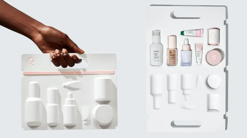 On the left: A person holding the Glossier Skincare Edit kit. On the right: The Glossier Skincare Edit packaging lays open to reveal mini products.