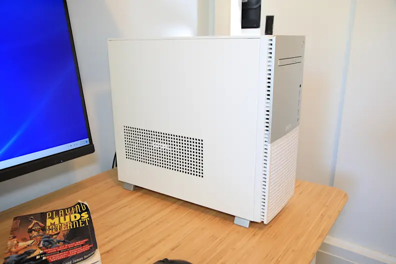 A white desktop computer tower sits on a desk.