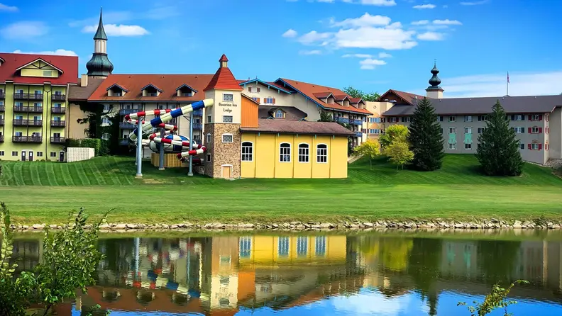 An exterior view of a family vacation hotel from across the pond