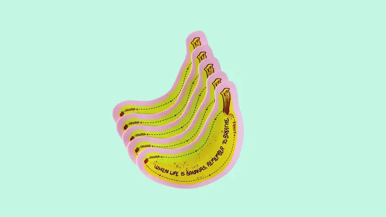 Front view of yellow sensory stickers from Calm Strips Bananas on a light teal background.