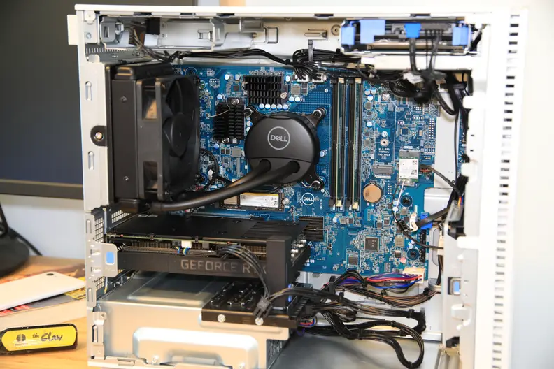 The interior of a Dell desktop tower showing the inner machinery.