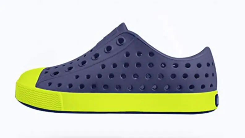 A blue Natives shoe with a bright green sole.
